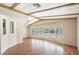 Spacious living room with large windows, wood-beamed ceiling, and laminate flooring at 9302 E Broadway Rd # 42, Mesa, AZ 85208
