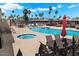 Inviting kidney-shaped pool and spa with lounge chairs and umbrellas at 9302 E Broadway Rd # 42, Mesa, AZ 85208