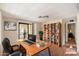 Home office with wood desk and built-in shelving at 9302 E Broadway Rd # 42, Mesa, AZ 85208