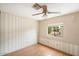 Bedroom with wood floors and vertical striped wallpaper at 9302 E Broadway Rd # 42, Mesa, AZ 85208