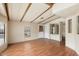 Living room with wood-beamed ceiling, laminate flooring, and built-in shelving at 9302 E Broadway Rd # 42, Mesa, AZ 85208