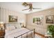 Virtually staged bedroom with a metal bed frame and wood floors at 9302 E Broadway Rd # 42, Mesa, AZ 85208