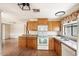Kitchen with wood cabinets, white appliances, and laminate flooring at 9302 E Broadway Rd # 42, Mesa, AZ 85208