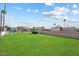 Fenced dog park with grassy area and palm trees at 9302 E Broadway Rd # 42, Mesa, AZ 85208