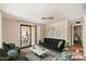 Living room with green sofa and access to a patio at 9302 E Broadway Rd # 42, Mesa, AZ 85208