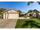 Ranch-style home with a two-car garage and well-manicured lawn at 12903 W Blue Sky Dr, Sun City West, AZ 85375