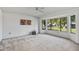 Spacious living room featuring large windows and neutral carpeting at 12903 W Blue Sky Dr, Sun City West, AZ 85375