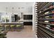 Modern kitchen features dark cabinetry, wine storage, and a large quartz island at 9622 W Villa Chula Dr, Peoria, AZ 85383