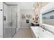 Modern bathroom with walk-in shower, freestanding tub, and floating double vanity at 9622 W Villa Chula Dr, Peoria, AZ 85383