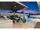 Outdoor kitchen with built-in grill and dining area at 9622 W Villa Chula Dr, Peoria, AZ 85383