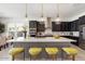 Modern kitchen with island, custom cabinetry, and breakfast bar at 9622 W Villa Chula Dr, Peoria, AZ 85383