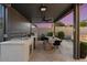 Outdoor kitchen with a sink, grill, and dining table at 9622 W Villa Chula Dr, Peoria, AZ 85383