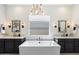 Spa-like bathroom with soaking tub, double vanity, and frameless shower at 9622 W Villa Chula Dr, Peoria, AZ 85383