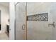 Modern shower with marble tile and a glass enclosure at 9622 W Villa Chula Dr, Peoria, AZ 85383