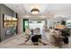 Open living room with fireplace, large TV, and access to backyard pool at 9622 W Villa Chula Dr, Peoria, AZ 85383