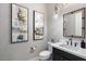 Powder room with a modern vanity and stylish wall decor at 9622 W Villa Chula Dr, Peoria, AZ 85383