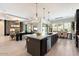 Open kitchen with large island, breakfast bar, and views into adjacent living area at 9622 W Villa Chula Dr, Peoria, AZ 85383
