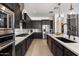 Luxury kitchen with stainless steel appliances, dark cabinetry, and a large island at 9622 W Villa Chula Dr, Peoria, AZ 85383