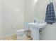 Clean and modern half bathroom with pedestal sink at 10523 E Simone Ave, Mesa, AZ 85212