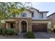 Two-story home with stone accents and a two-car garage at 10523 E Simone Ave, Mesa, AZ 85212