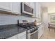 Modern kitchen with stainless steel appliances and granite countertops at 10523 E Simone Ave, Mesa, AZ 85212