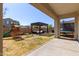 Large backyard with playground, covered patio, and trampoline at 10523 E Simone Ave, Mesa, AZ 85212
