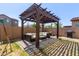 Relaxing backyard patio with pergola and seating at 10523 E Simone Ave, Mesa, AZ 85212