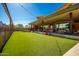 Community lawn with string lights and games at 10523 E Simone Ave, Mesa, AZ 85212