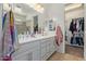 Double vanity bathroom with a walk-in shower and closet at 10523 E Simone Ave, Mesa, AZ 85212