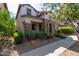 Two-story house with stone and stucco exterior, landscaped yard at 10523 E Simone Ave, Mesa, AZ 85212