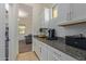 Convenient laundry room with granite countertop and built in cabinets at 10523 E Simone Ave, Mesa, AZ 85212