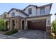 Two-story home with stone accents and a three-car garage at 10523 E Simone Ave, Mesa, AZ 85212