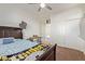 Spacious bedroom with a double bed, built-in shelves, and a view of the upper level at 10523 E Simone Ave, Mesa, AZ 85212