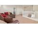 Open loft area with a couch, carpet, and white railing at 10523 E Simone Ave, Mesa, AZ 85212