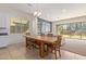 Bright dining area with wooden table and view to backyard at 10523 E Simone Ave, Mesa, AZ 85212
