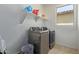Laundry room with washer, dryer, and shelving at 10523 E Simone Ave, Mesa, AZ 85212