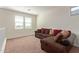 Bright loft bedroom with a L-shaped couch and plenty of windows at 10523 E Simone Ave, Mesa, AZ 85212