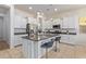 White kitchen with stainless steel appliances and island at 10523 E Simone Ave, Mesa, AZ 85212