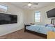 Bright bedroom with a double bed, TV, and plenty of closet space at 10523 E Simone Ave, Mesa, AZ 85212