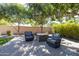 Relaxing patio seating area with fire pit, under shade trees at 2057 E Marquette Dr, Gilbert, AZ 85234