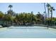 Tennis court with palm trees and lush landscaping at 2057 E Marquette Dr, Gilbert, AZ 85234