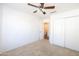 Spacious bedroom featuring a ceiling fan and double door closet at 2057 E Marquette Dr, Gilbert, AZ 85234