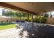 Covered patio, grassy backyard, and seating area with fire pit at 2057 E Marquette Dr, Gilbert, AZ 85234