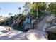 Steps leading to a peaceful waterfall; community amenity at 2057 E Marquette Dr, Gilbert, AZ 85234