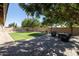 Landscaped backyard with grassy area, patio, and fire pit at 2057 E Marquette Dr, Gilbert, AZ 85234