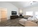 Living room with large sectional sofa, fireplace, and access to backyard at 2057 E Marquette Dr, Gilbert, AZ 85234