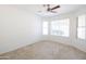 Well-lit bedroom with large window and ceiling fan at 2057 E Marquette Dr, Gilbert, AZ 85234