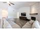 Bright living room features a sectional sofa, fireplace and wood-look tile floors at 2057 E Marquette Dr, Gilbert, AZ 85234