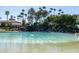 Clear lagoon pool with sandy beach; perfect for swimming at 2057 E Marquette Dr, Gilbert, AZ 85234