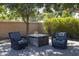 Relaxing patio seating area with fire pit, under shade trees at 2057 E Marquette Dr, Gilbert, AZ 85234